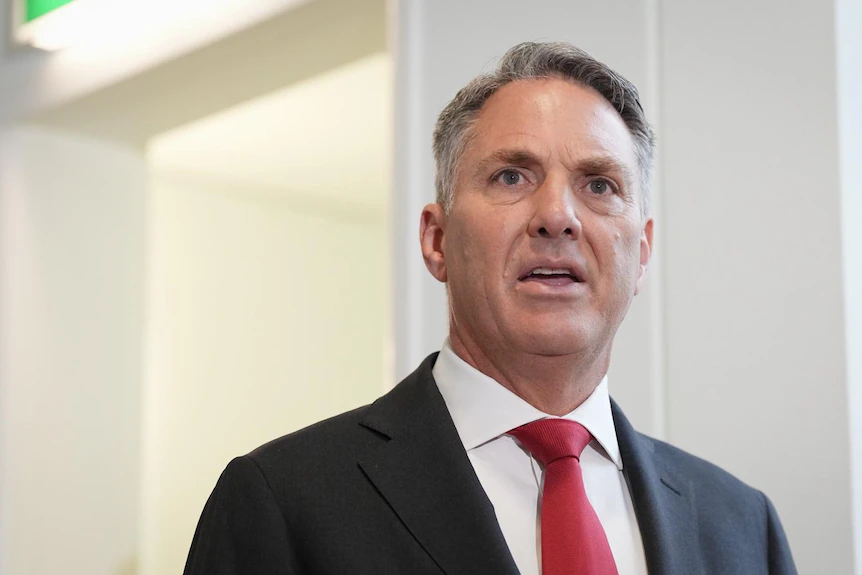 a male politician wearing a red tie and suit