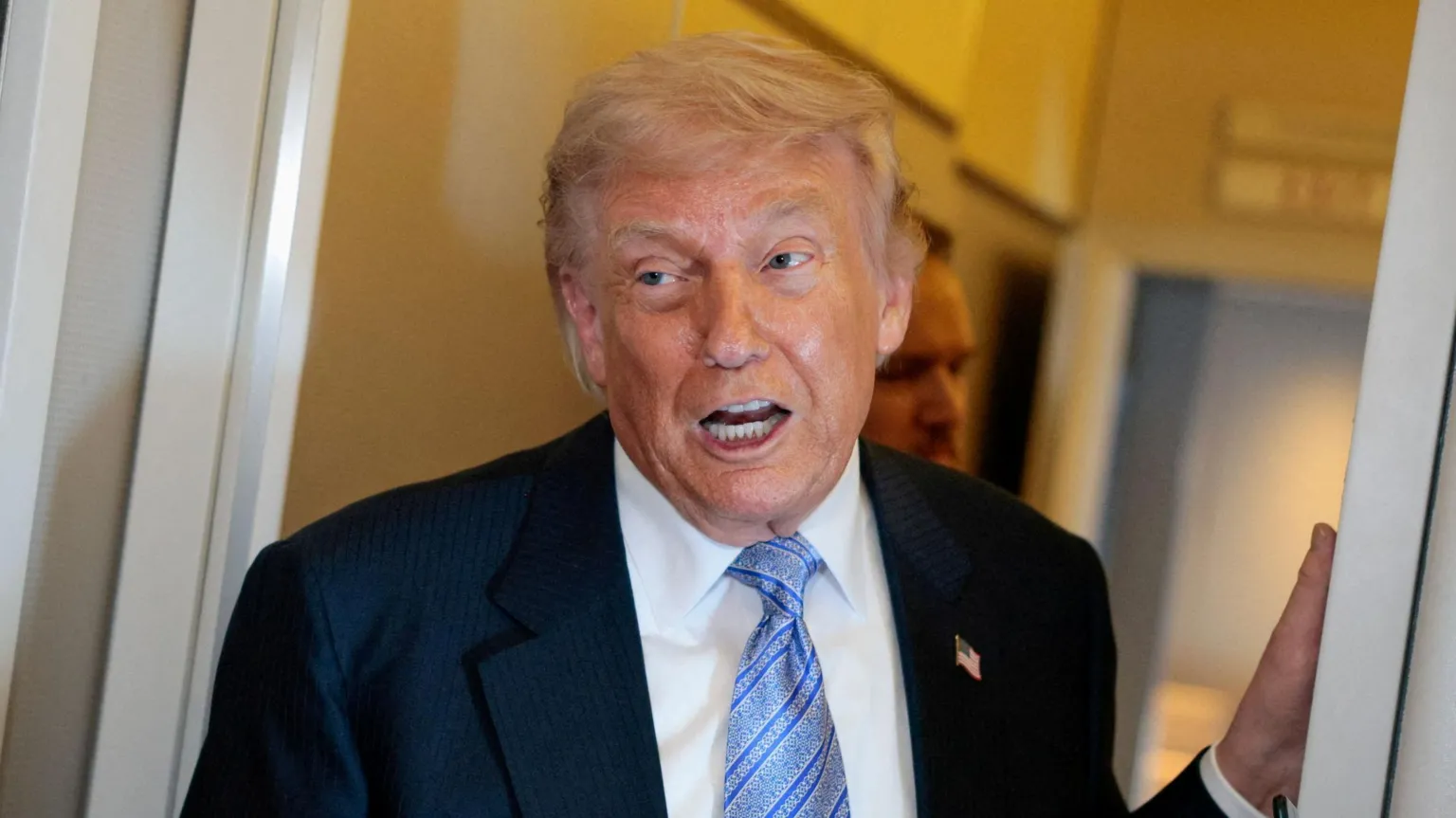 U.S. President Donald Trump speaks to the press aboard Air Force One on 15 May