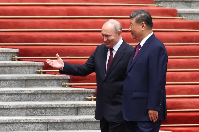 Putin and Xi walk together during a welcoming ceremony at the Great Hall of the People in Beijing.