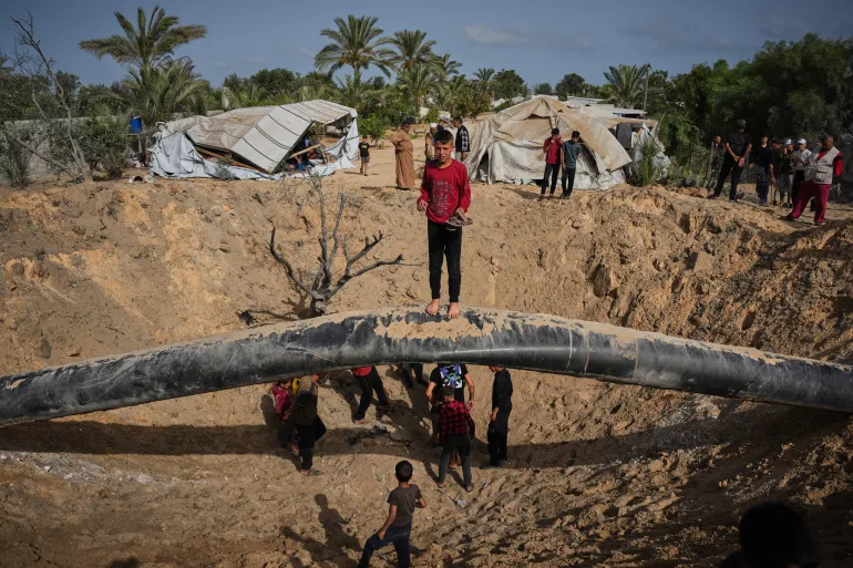 Palestinian children amid destruction from Israeli strike in Khan Younis, Gaza Strip.