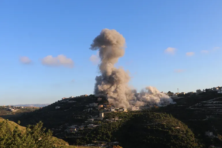 Smoke billows from Deir Qanoun an-Naher village in southern Lebanon after Israeli military operations despite ceasefire.