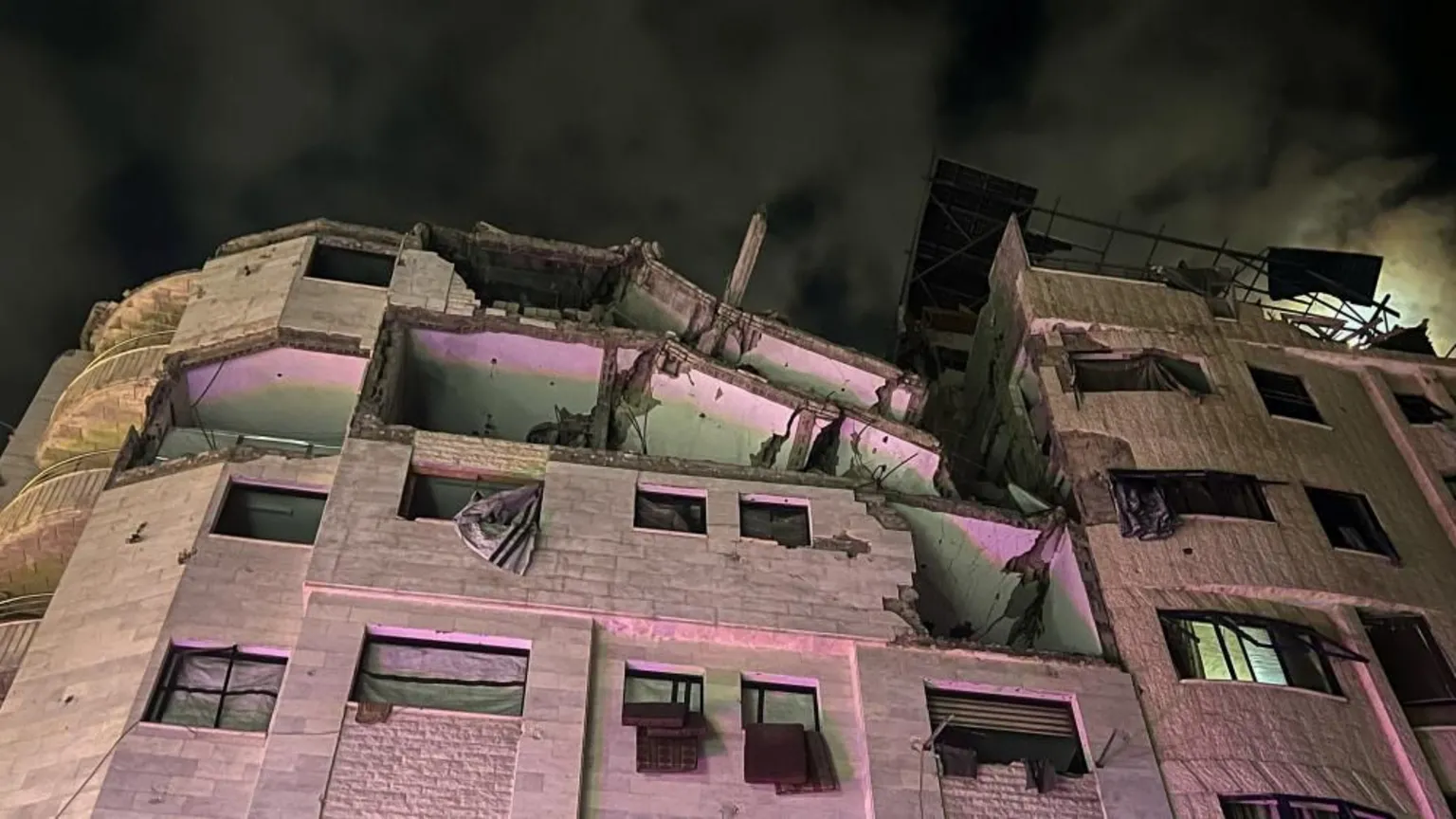 Damaged building in Gaza City's market district following Israeli air strike targeting Hamas military commander.