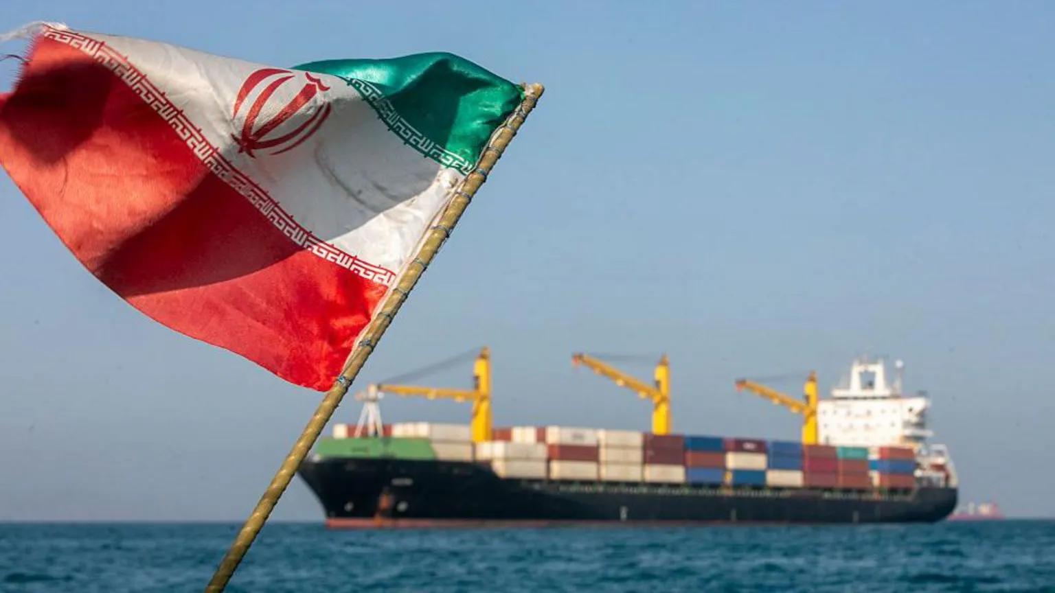 Getty Images An Iranian flag flutters in the wind as ships remain anchored on May 16, 2026 in the Strait of Hormuz near Larak Island, Iran. Negotiations between the U.S. and Iran over opening this critical waterway have largely stalled as the countries have rejected each other's proposals to end the war that began when the U.S. and Israel attacked Iran on February 28. (Photo by Majid Saeedi/Getty Images)