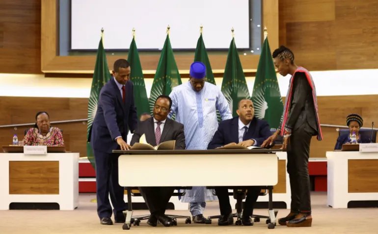 Ethiopian government representative Redwan Hussein and Tigray delegate Getachew Reda sign ceasefire agreement in 2022.