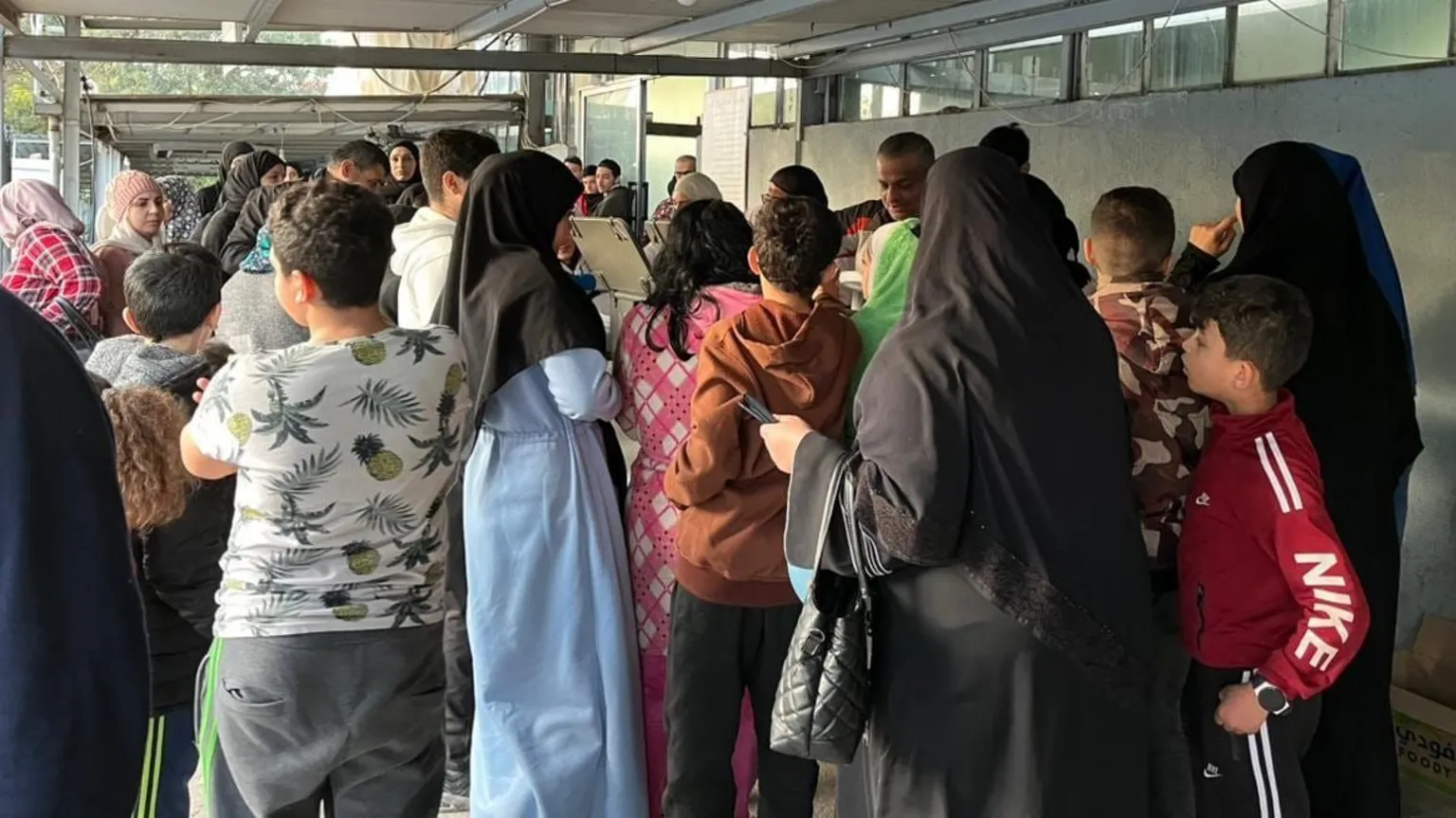 Overcrowded food kitchen serves displaced residents who have fled homes amid escalating Israel-Hezbollah conflict.