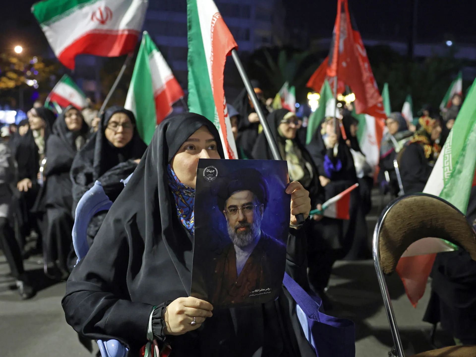 A woman holds a portrait of Iran's Supreme Leader Mojataba Khamenei during a protest against the US and Israel in Tehran on May 29, 2026 [AFP]