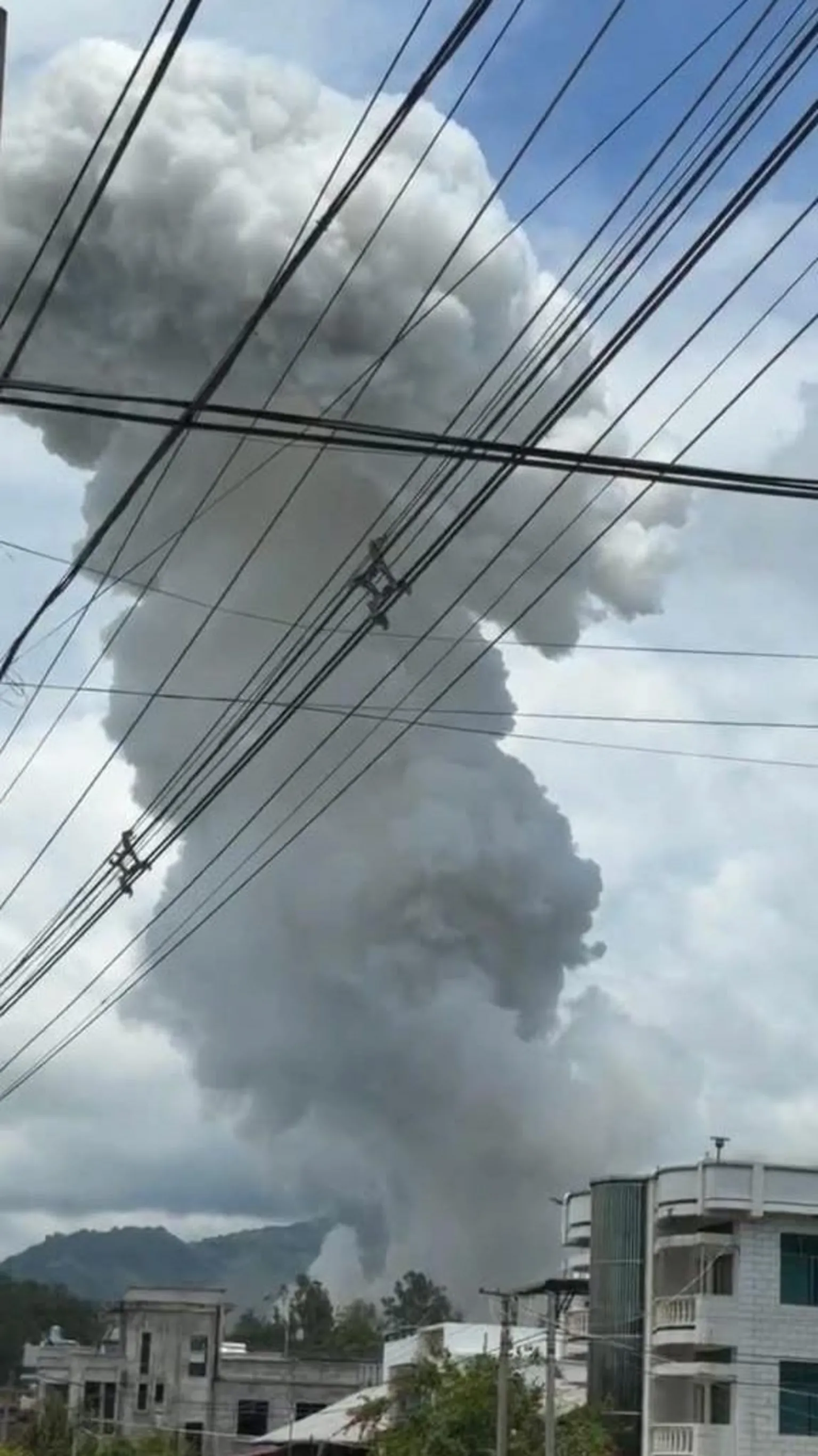 Shwe Phee Myay A huge plume of smoke rises over a village.