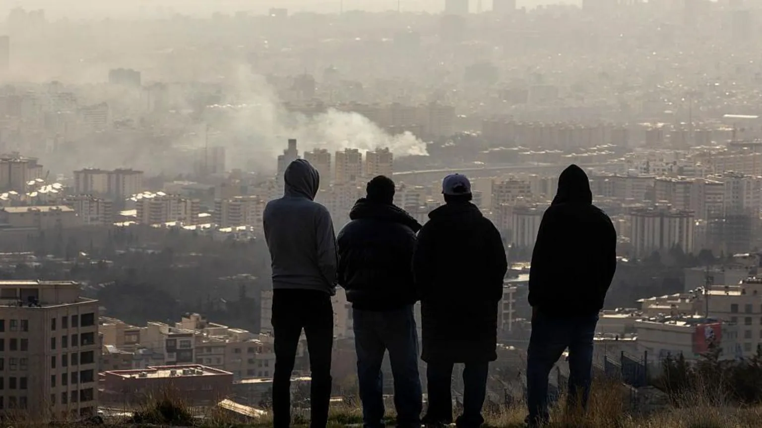 Smoke and damage visible across Tehran skyline after days of sustained US-Israeli aerial strikes.