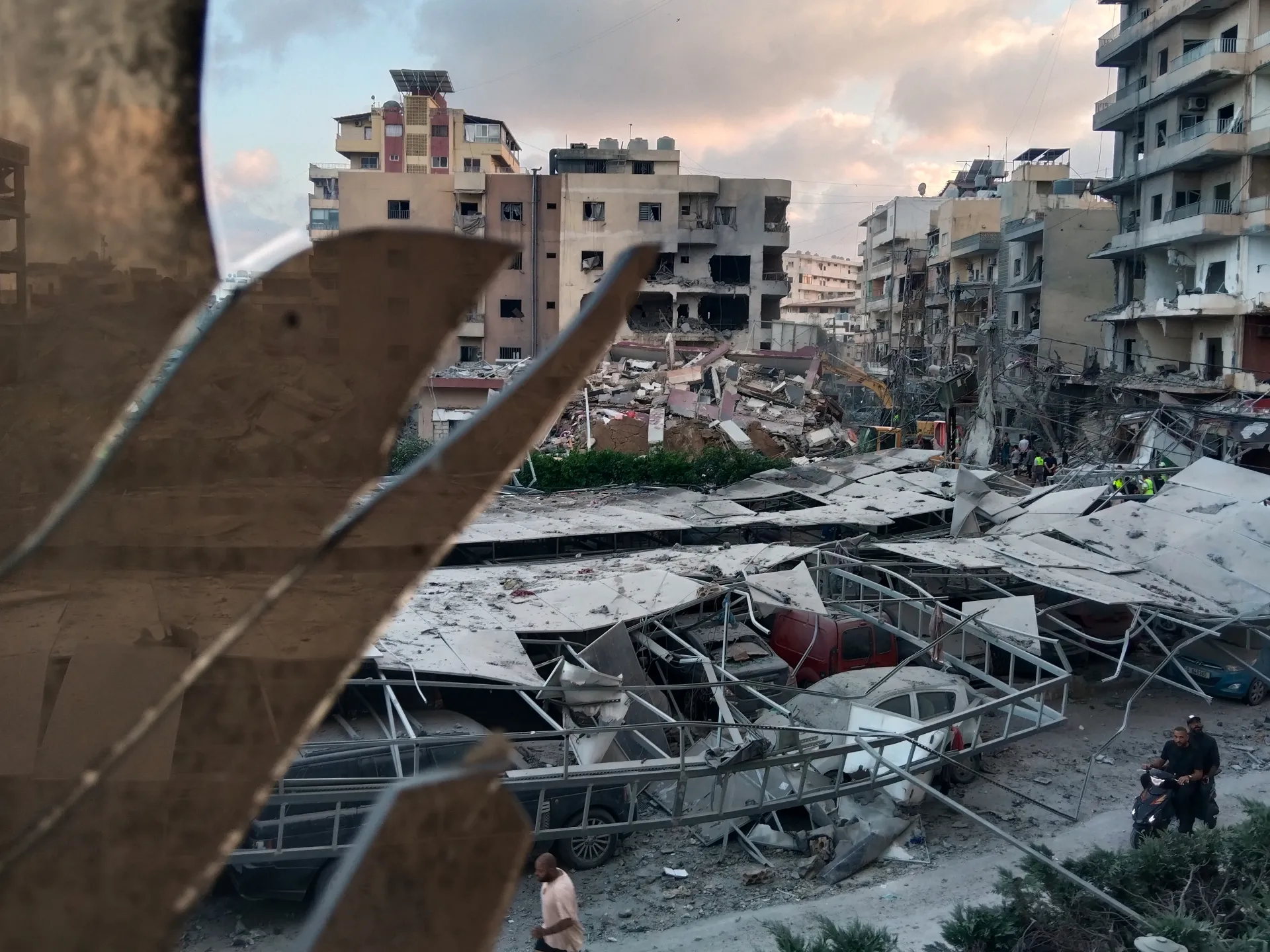 A destroyed building hit by an Israeli air strike is seen through a shattered window of the Jabal Amel Hospital in the southern port city of Tyre, Lebanon, on June 1, 2026 [AP]