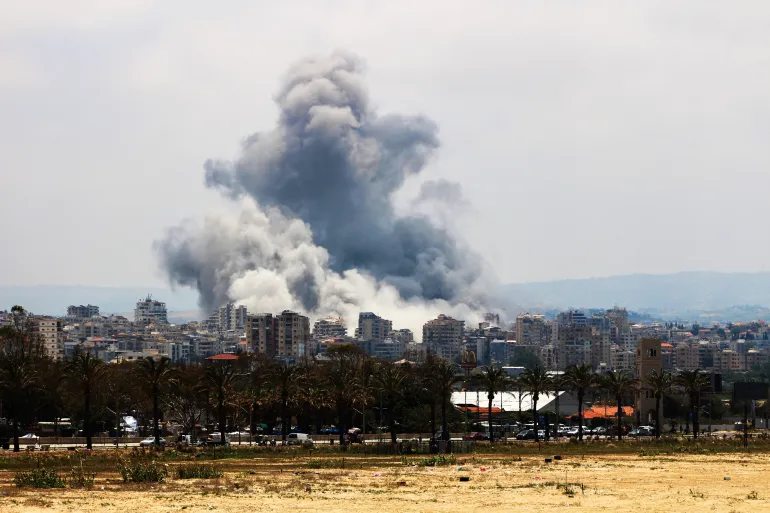 Smoke plume rises from Israeli attack on outskirts of Tyre, southern Lebanon, endangering nearby ancient heritage sites.