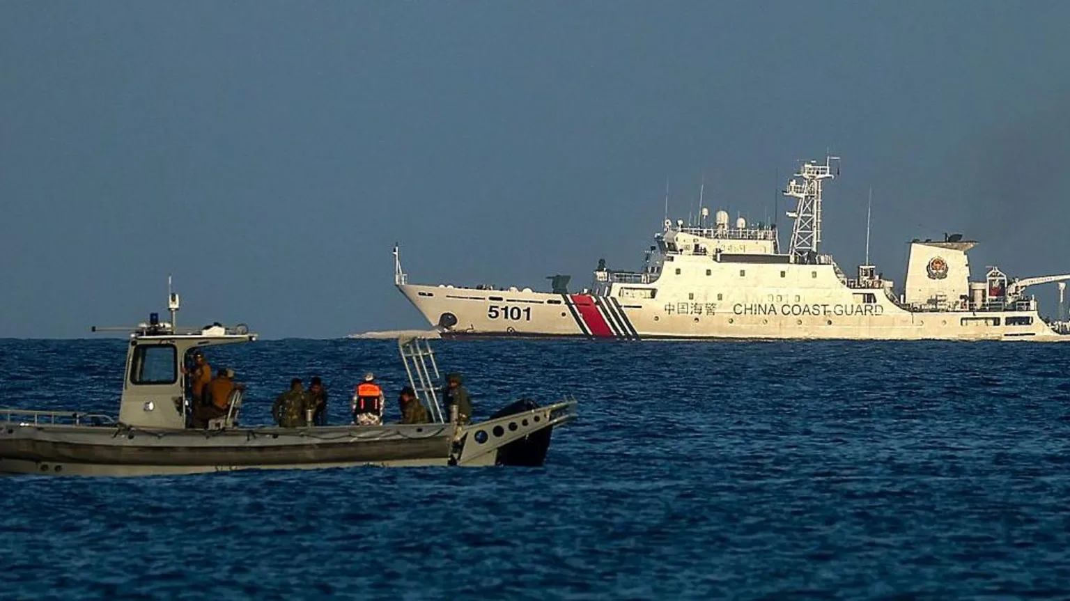Philippine and Chinese vessels navigate tense waters amid competing territorial claims in South China Sea.
