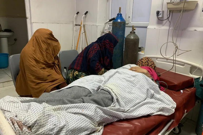 A wounded Afghan woman receives treatment at a hospital in Jalalabad after an overnight Pakistani mortar shell hit a camp for people returning from Pakistan during clashes bnear the Torkham border crossing [Aimal Zahir / AFP]