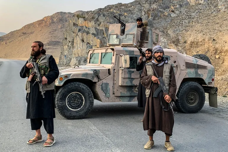 Taliban security personnel stand guard near the Torkham border crossing between Afghanistan and Pakistan in Nangarhar province [Aimal Zahir / AFP]