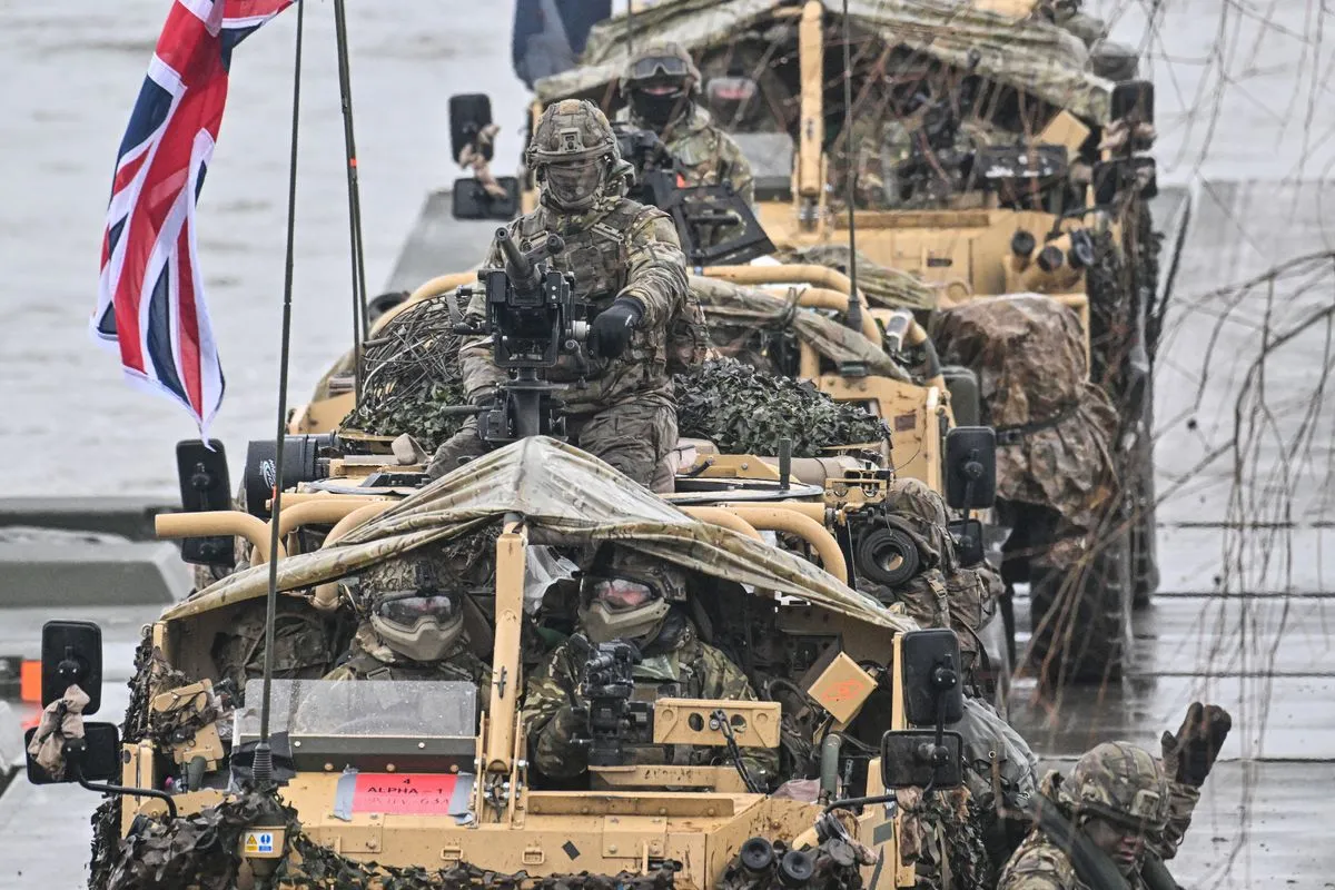 British soldiers stand inside armoured vehicles as they cross the Vistula River during the DRAGON-24 NATO military defense drills on March 05, 2024 in Korzeniewo