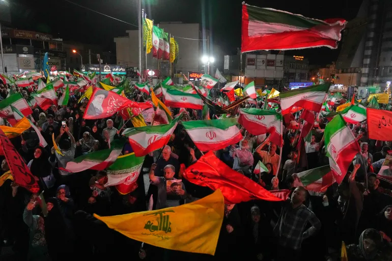 Pro-government Iranian demonstrators wave flags of Iran and Hezbollah in Tehran, June 7, 2026 [Vahid Salemi/AP Photo]