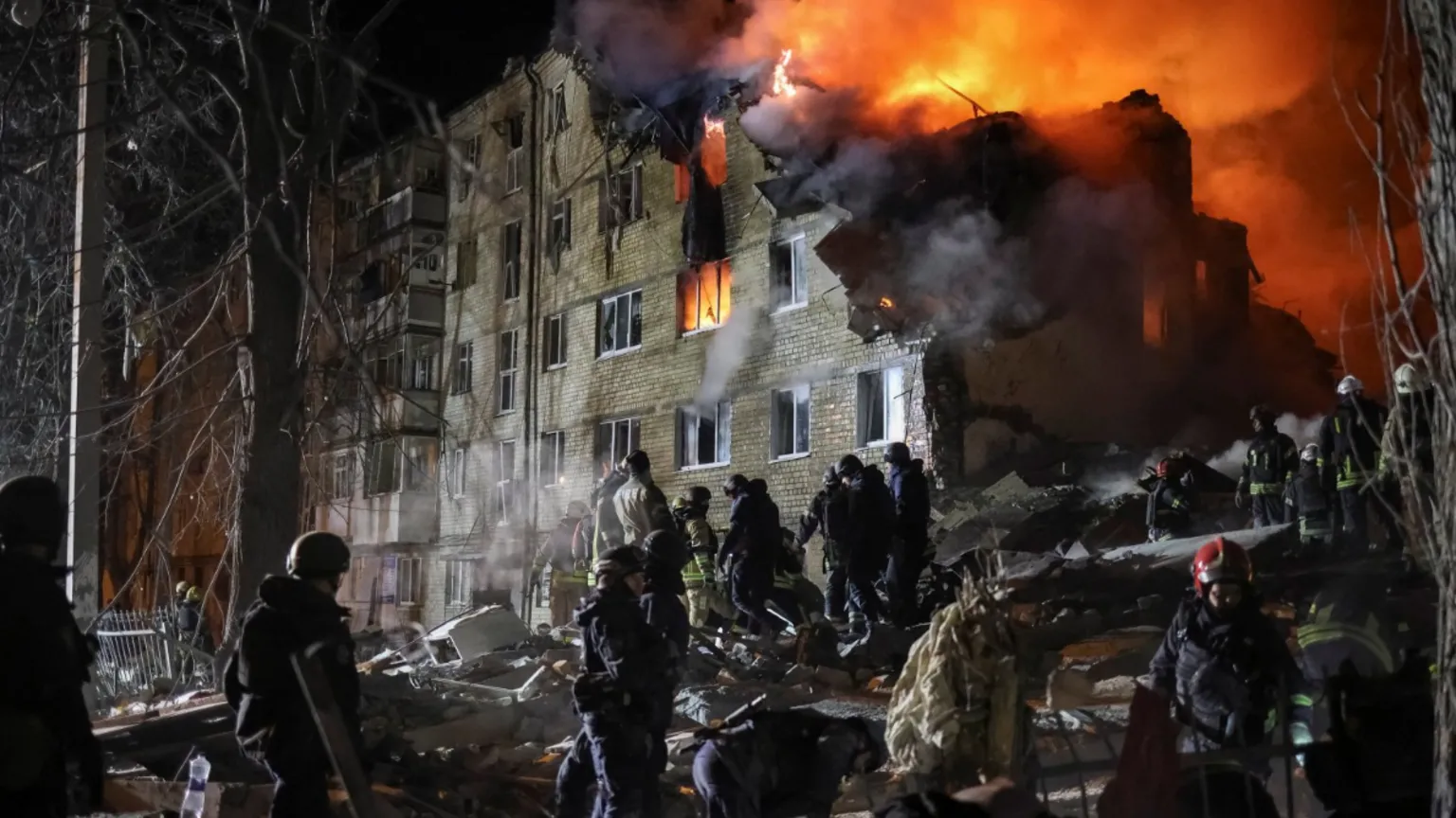 Rescuers work at the site of the apartment building hit by a Russian missile strike in Kharkiv