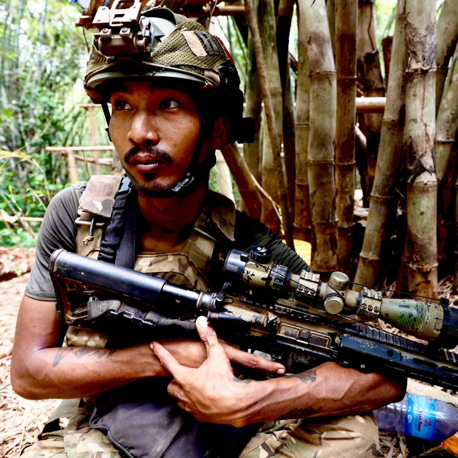 Myanmar soldier armed in jungle terrain during military operations against resistance forces.