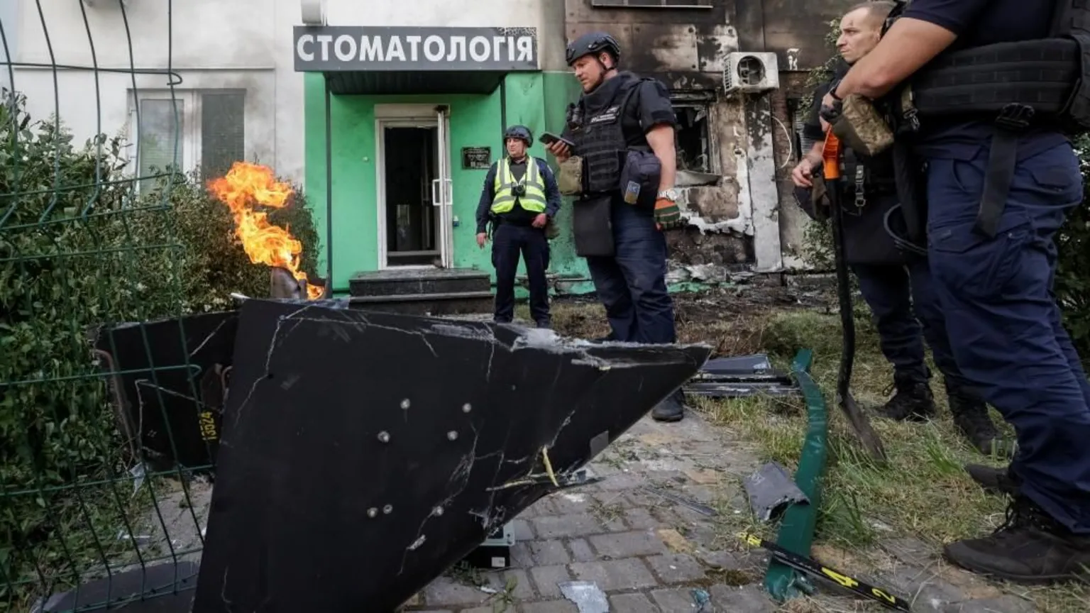 Emergency responders investigate damage from Russian drone strike on residential area in Kharkiv, northeastern Ukraine.