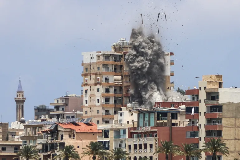 Smoke and debris rise from Israeli airstrikes in Tyre, Lebanon, as ceasefire agreement fractures.