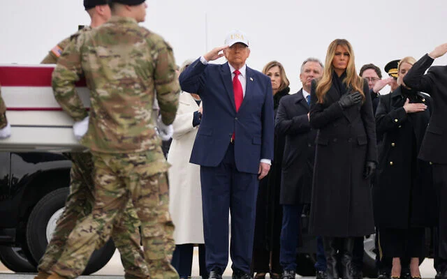 A US Army carry team moves a flag-draped transfer case with the remains of US Army Reserve soldier Sgt. 1st Class Nicole Amor, of White Bear Lake, Minn., who was killed in a drone strike at a command center in Kuwait after the US and Israel launched its military campaign against Iran, past President Donald Trump and first lady Melania Trump during a casualty return, Saturday, March 7, 2026, at Dover Air Force Base, Delaware. (AP Photo/Mark Schiefelbein)