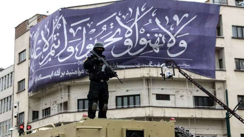 An Iranian security officer stands guard during a government rally in Tehran on March 13, 2026. Photo credits: AFP