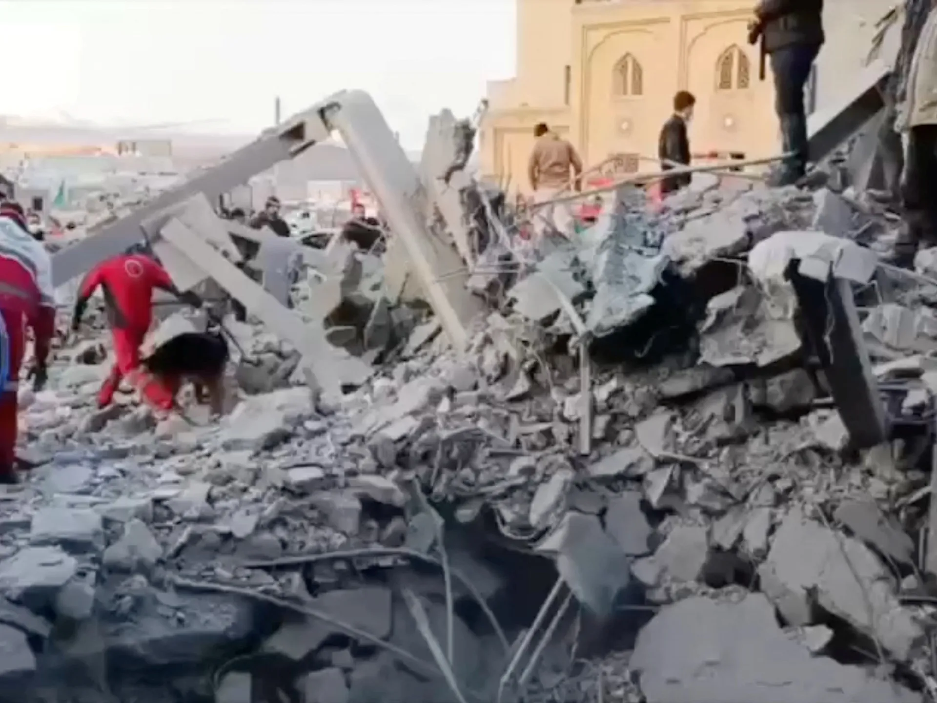 Members of the Iranian Red Crescent Society work at the site of a US-Israeli strike near a mosque in Zanjan, Iran [Iranian Red Crescent Society/Handout via Reuters]