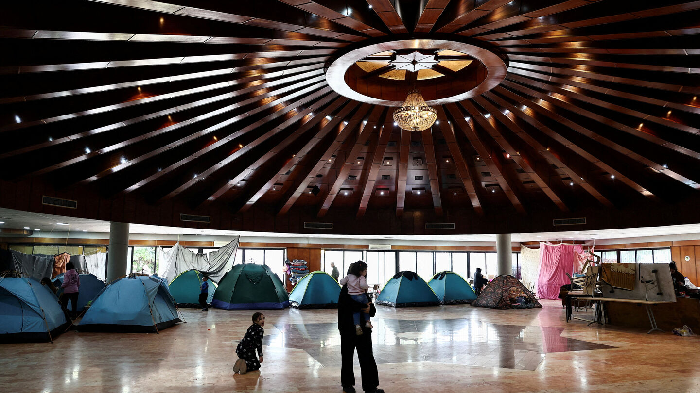 A woman holds a child in a school turned into a shelter for displaced families, amid escalating hostilities between Israel and Hezbollah, as the U.S.-Israeli conflict with Iran continues, in Dekwaneh, Lebanon. REUTERS/Yara Nardi — Yara Nardi