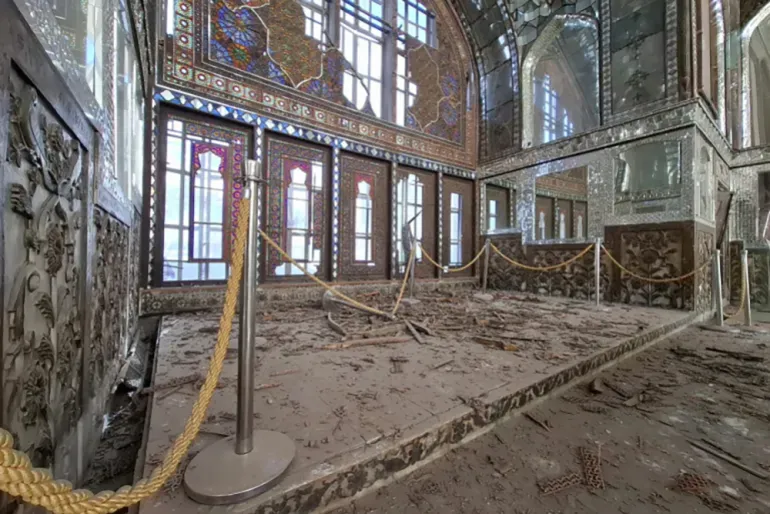 Rubble scattered inside a historic hall at Golestan Palace following recent military strikes.