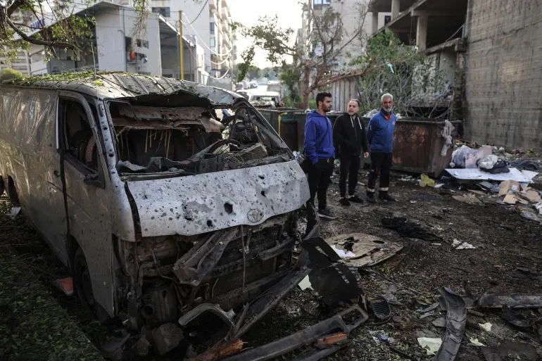 Destroyed vehicle wreckage at the site of an Israeli strike in Beirut's southern suburbs.