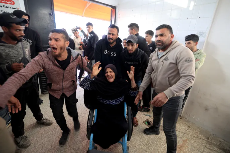 Family members arrive at Al-Aqsa Martyrs Hospital in Deir el-Balah following Israeli airstrike in Maghazi refugee camp.