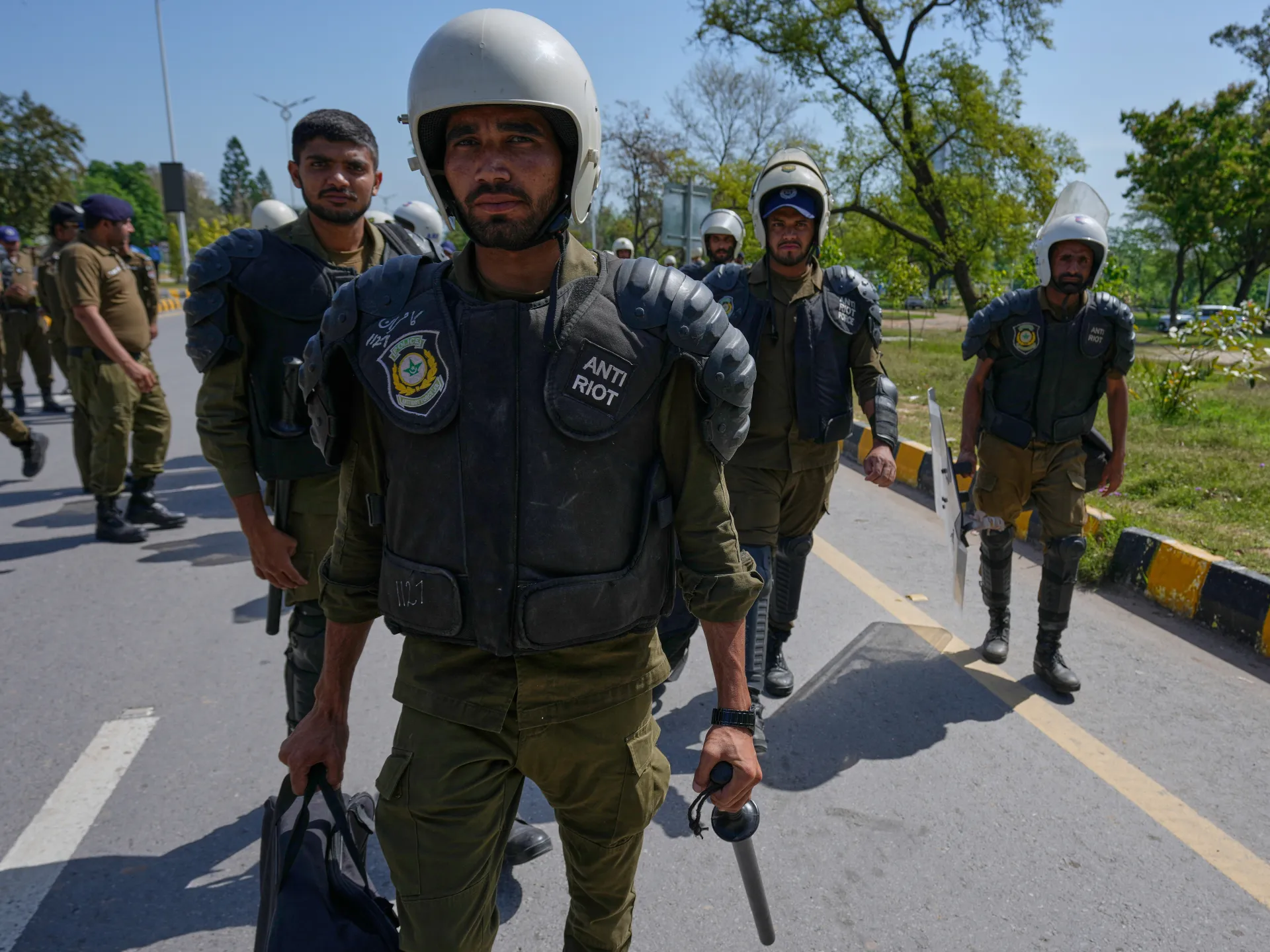 Police officers walk towards bus for their deployment in Islamabad, Pakistan before planned US-Iran ceasefire talks [File: Anjum Naveed/The Associated Press]