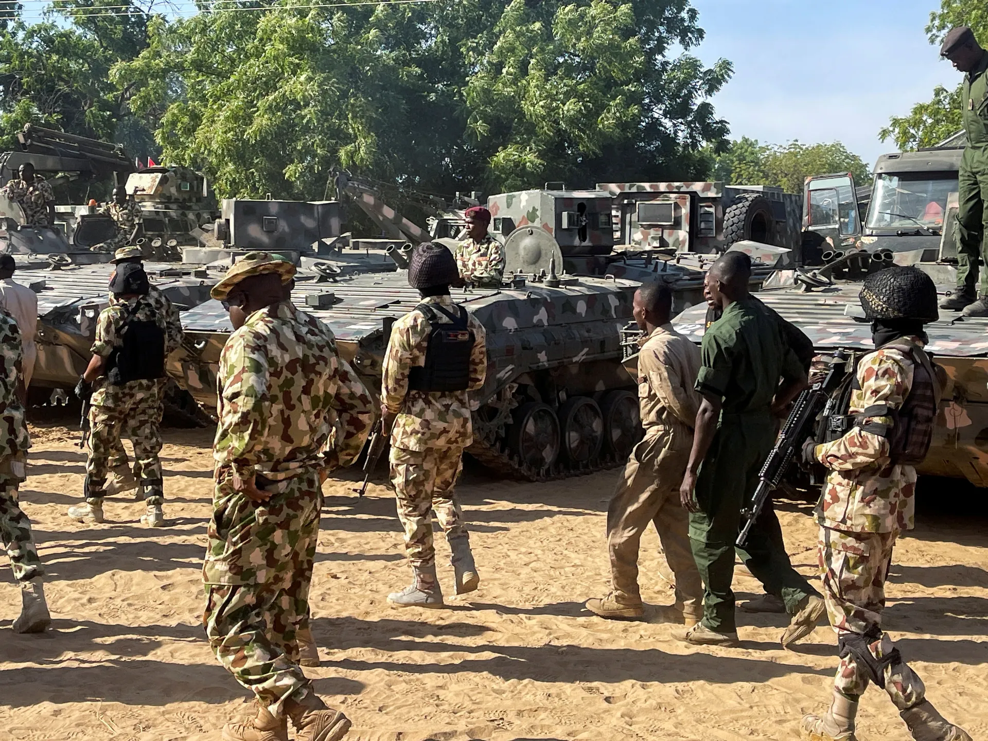 Nigerian soldiers walk past military tanks in Maiduguri, Borno State, Nigeria on November 7, 2025 [File: Ahmed Kingimi/Reuters]