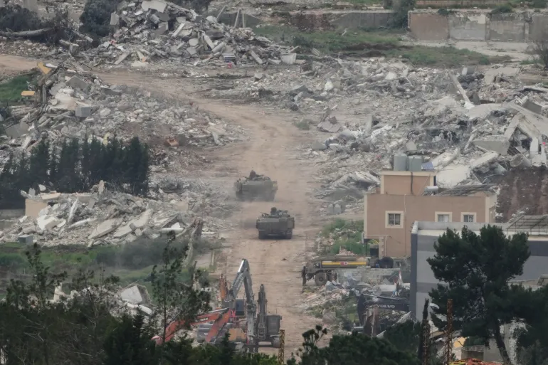 Israeli army vehicles and bulldozers operate in southern Lebanon during ongoing military offensive.