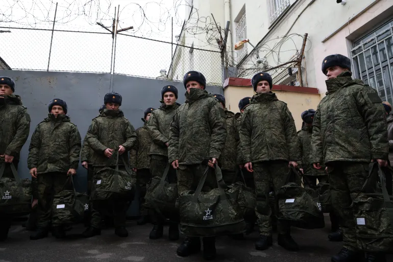 Russian conscripts gather for a ceremony marking their departure for assigned military units.