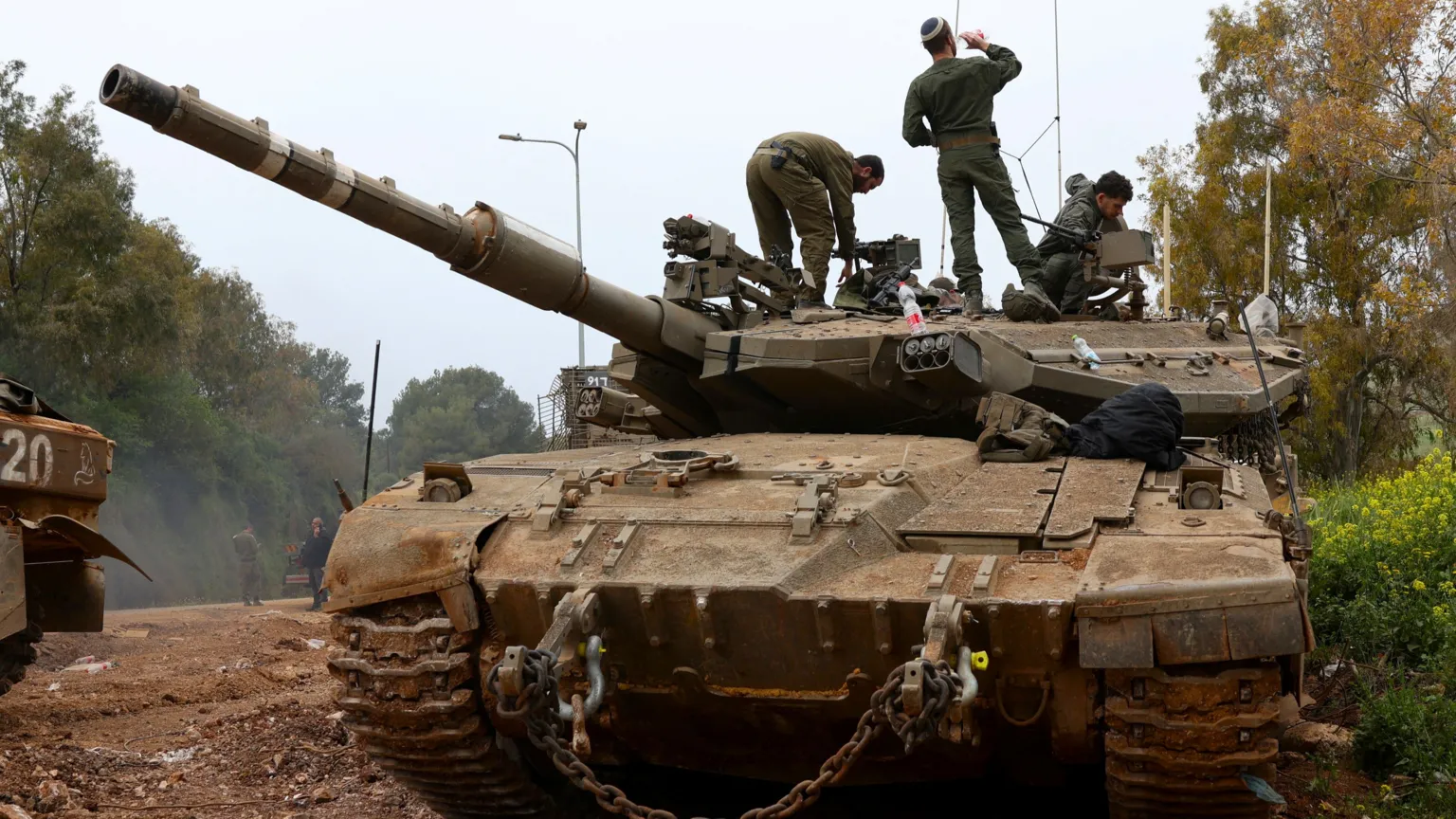 Israeli soldiers positioned on tank near northern border as ceasefire takes effect Thursday evening.
