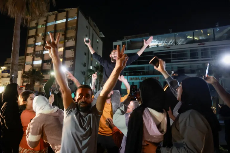 A crowd celebrates in the coastal city of Sidon [Aziz Taher/Reuters]