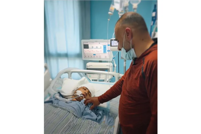 Thirteen-year-old Mohammad Saber al-Sheikh remains in critical condition in Ramallah hospital as his father keeps vigil.