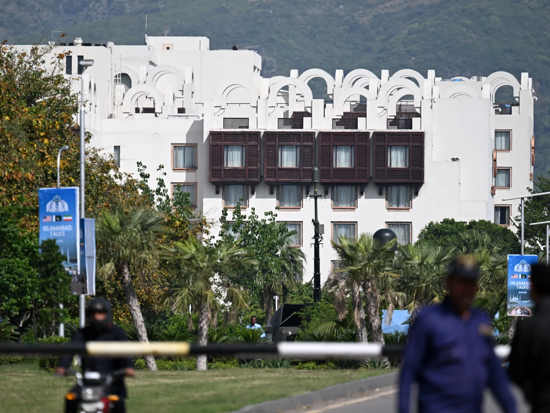 Police personnel stand guard near the Serena Hotel in the Red Zone area of Islamabad on April 21, 2026, amid heightened security measures in advance of anticipated US-Iran peace talks [AFP]
