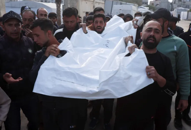 Mourners carry the body of a Palestinian killed in an Israeli air strike at Nasser Hospital in Khan Younis, Gaza.