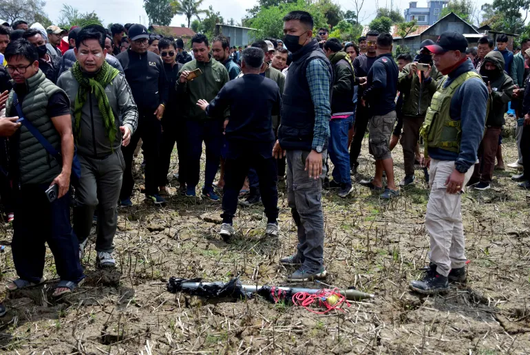 A defused explosive device lies on the ground in Bishnupur district after bomb disposal squad intervention.