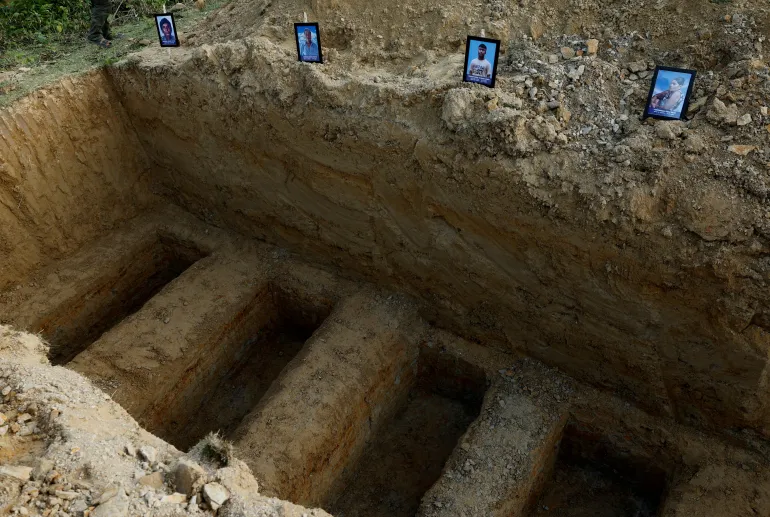 Photographs of deceased Meiteis killed in ethnic violence are placed at graves in Borobekra.