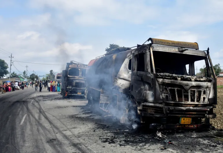Smoke billows from burned vehicles in Bishnupur district following an attack that killed seven people.