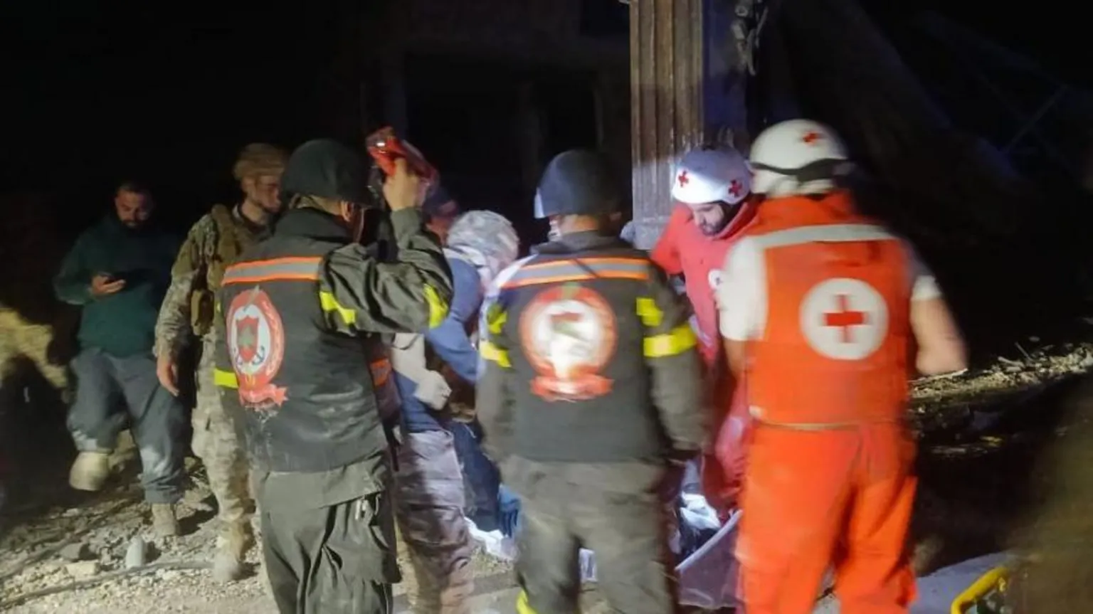 Lebanese Civil Defence rescue workers respond at the scene of an Israeli air strike that killed journalist Amal Khalil in Tayri.