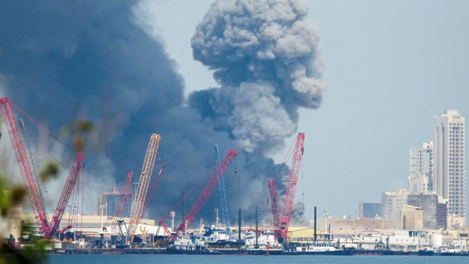 Black smoke rises above US Navy Fifth Fleet headquarters in Bahrain following Iranian missile attacks.