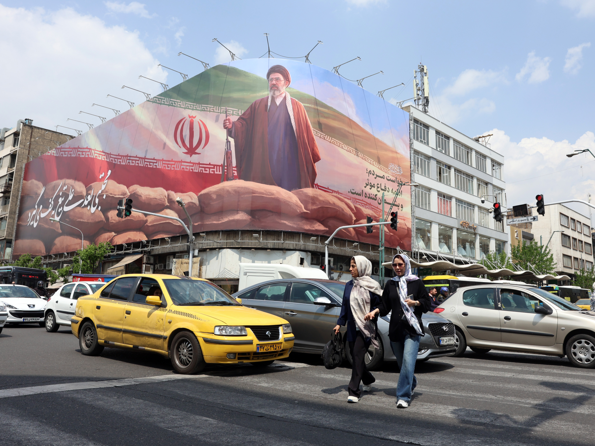 Iranians walk past a large billboard of Iranian Supreme Leader Ayatollah Mojtaba Khamenei on a street in Tehran, Iran, April 20, 2026 [Abedin Taherkenareh/EPA]