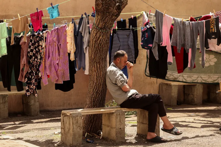 A displaced Lebanese man rests at a university-turned-shelter in Sidon after fleeing his home under Israeli evacuation orders.