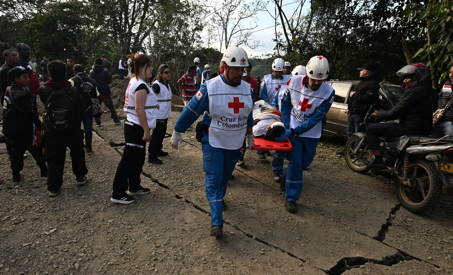 Emergency responders work at the scene of a bomb explosion on Colombia's Pan-American Highway in Cauca region Saturday.