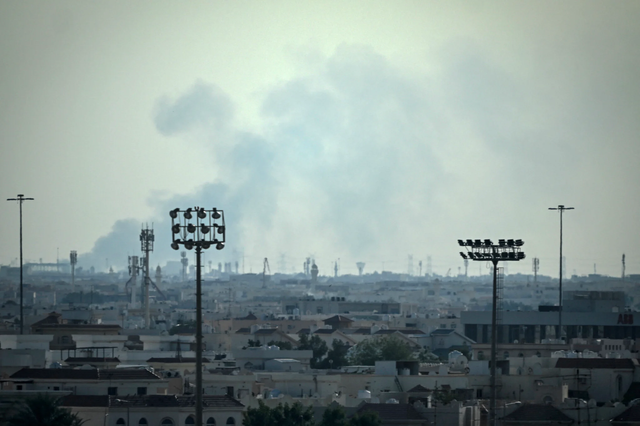 Smoke rises from an area in the direction of Al Udeid Air Base, which houses the Qatar Emiri Air Force and foreign forces including the US, in Doha on February 28, 2026, following a reported Iranian strike. (Photo by MAHMUD HAMS / AFP)
