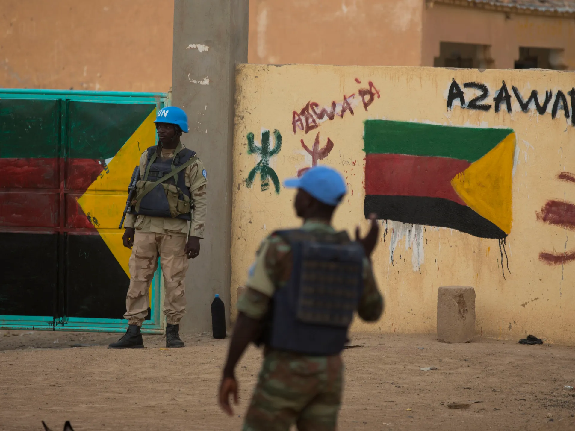 UN peacekeepers stand guard at the entrance to a polling station covered in separatist flags and graffiti supporting the creation of the independent state of Azawad, in Kidal, Mali on July, 27, 2013 [Rebecca Blackwell/AP Photo]