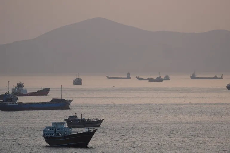Commercial and military vessels operate in the Strait of Hormuz amid heightened tensions between US and Iran forces.